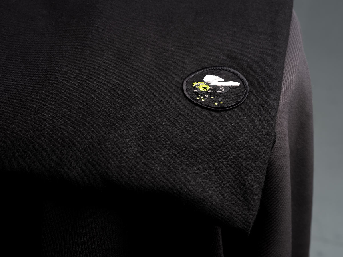MUTATIO patch on a shirt